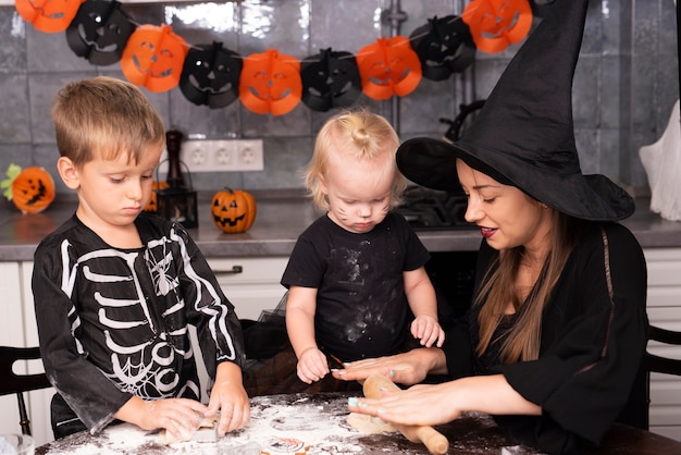 Front view of mother and kids making cookies