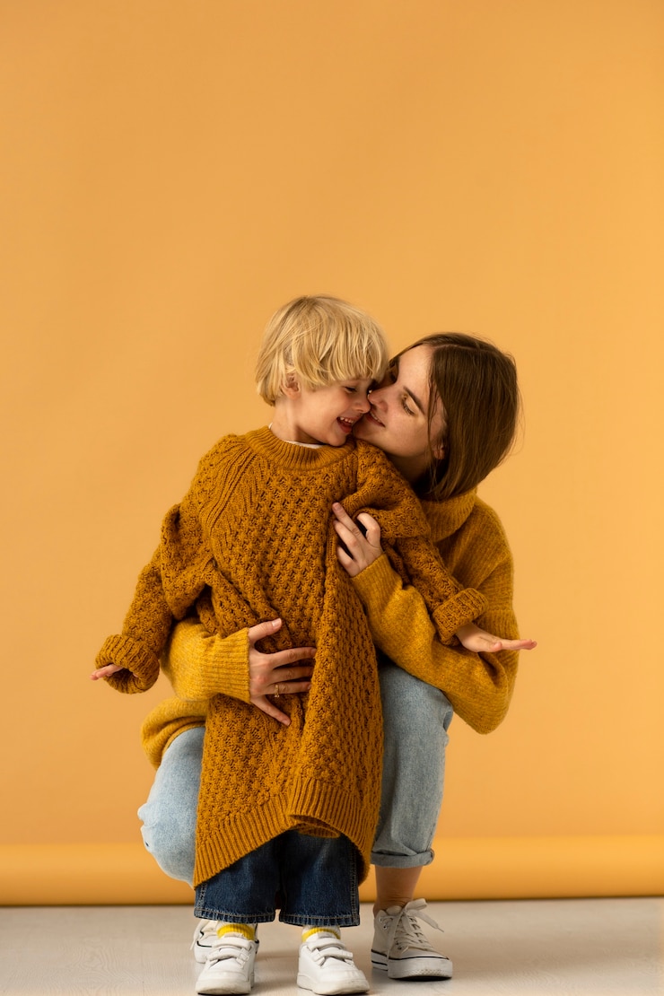 Free Photo front view mother kissing kid on cheek
