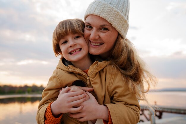 front view mother and son hanging out on a jetty