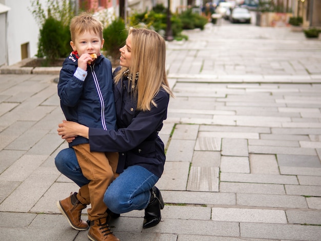 Free photo front view mother and son posing together