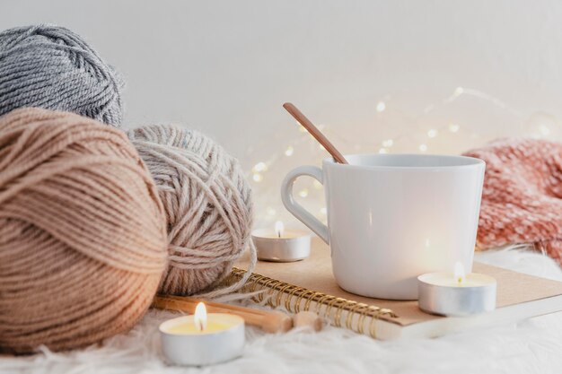 Front view mug with candles and yarn