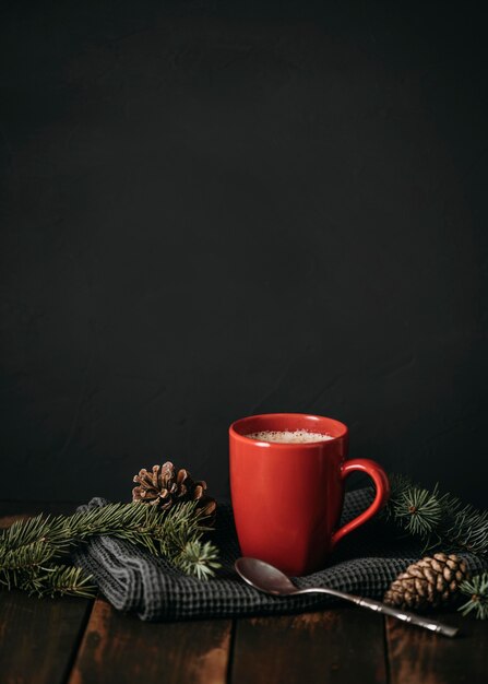 Front view mug with drink and pine cones