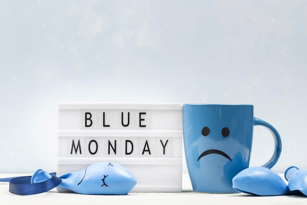 Front view of mug with frown and light box for blue monday