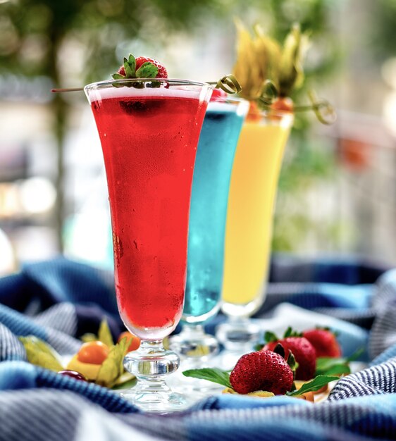 Front view multi-colored cocktails with fruit decor