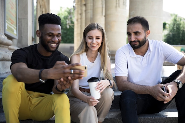 Front view multiethnic friends sitting