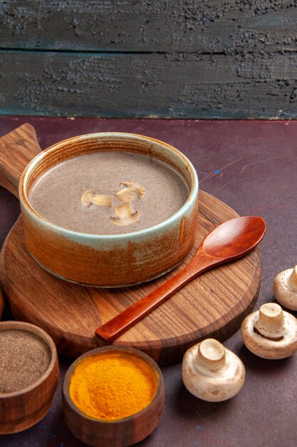 Front view mushroom soup with different seasonings on the dark space