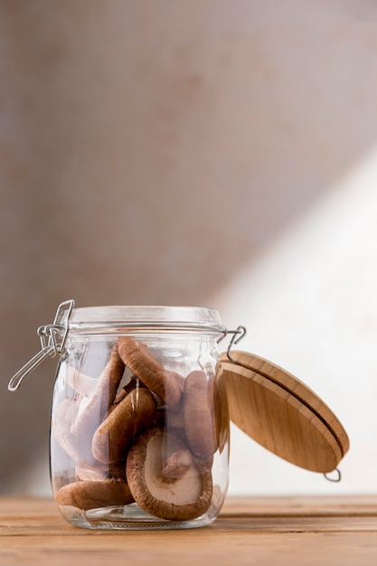 Free photo front view of mushrooms in jar with copy space