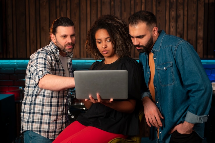 Free Photo front view musicians working with laptop