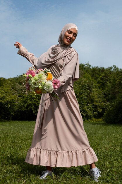 Front view muslim woman posing outdoors