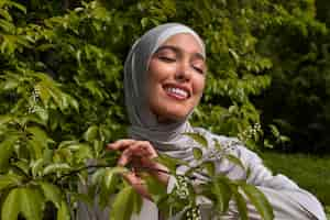 Free photo front view muslim woman posing outdoors