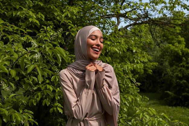Front view muslim woman posing outdoors