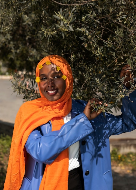 Free photo front view muslim woman posing outdoors