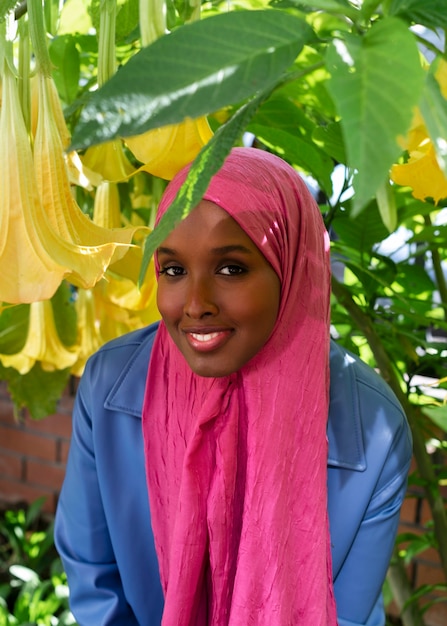 Free photo front view muslim woman posing outdoors