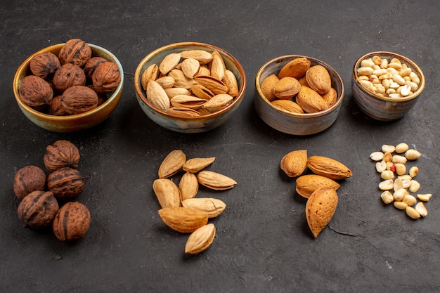 Front view of nut composition with different nuts on grey surface