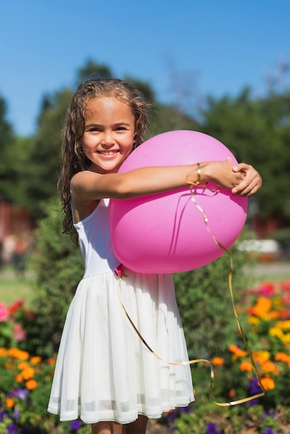 Бесплатное фото Вид спереди девушка держит воздушный шар