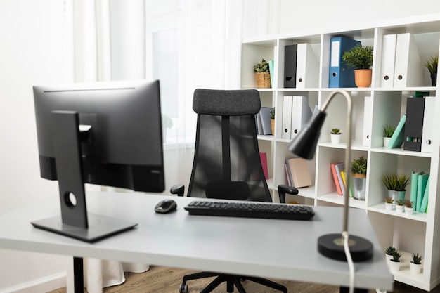 Front view of office desk with computer and chair