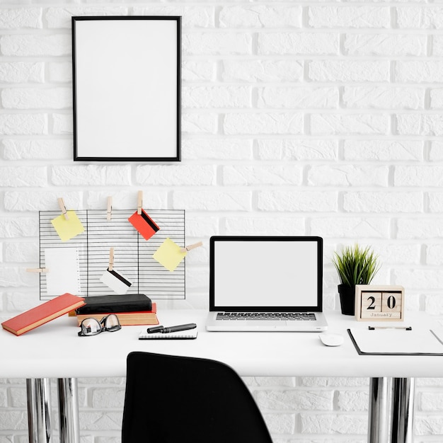 Free photo front view of office desk with laptop and chair