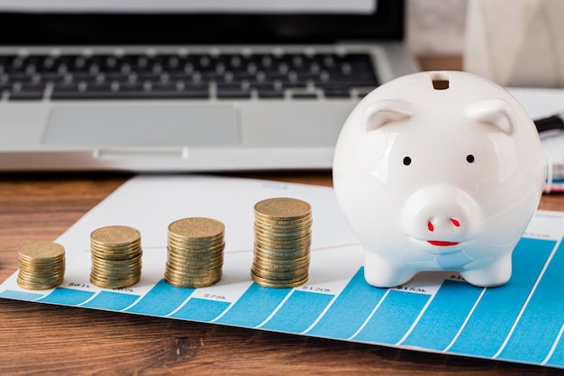 Front view of office items with piggy bank and coins