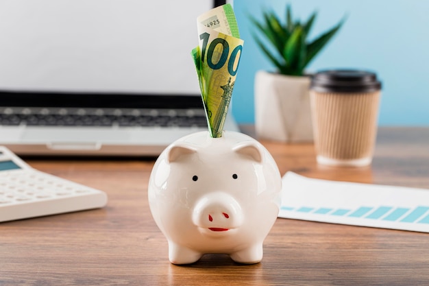 Front view of office items with piggy bank