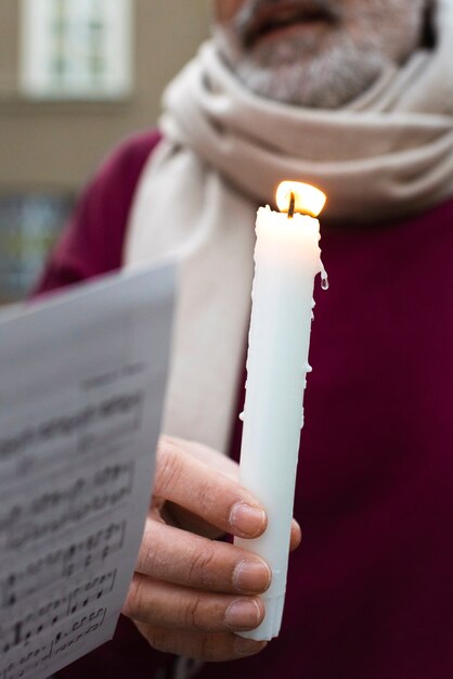 Front view old man holding candle