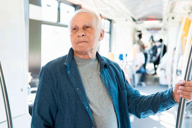 Front view of old man in public transportation