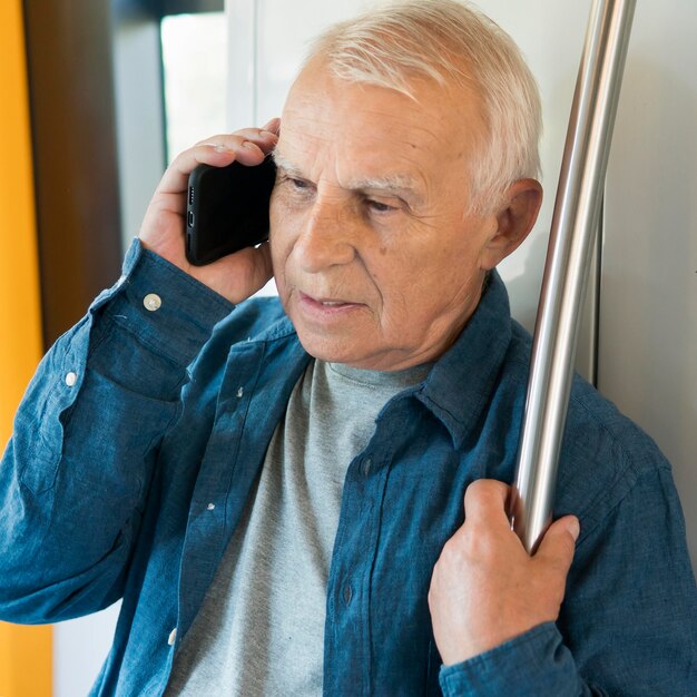 Front view of old man in public transportation