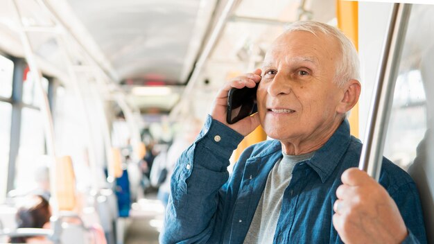 Front view of old man in public transportation