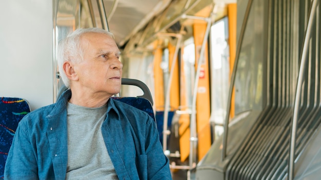 Front view of old man in public transportation