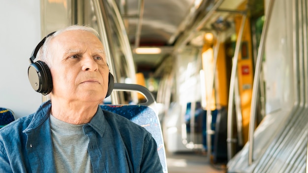 Free photo front view of old man in public transportation