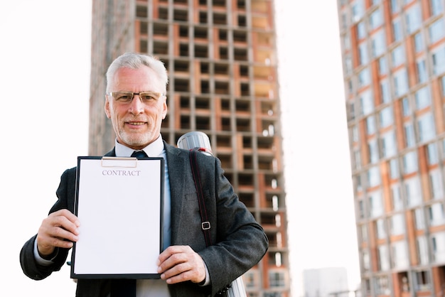 Front view old man with contract 