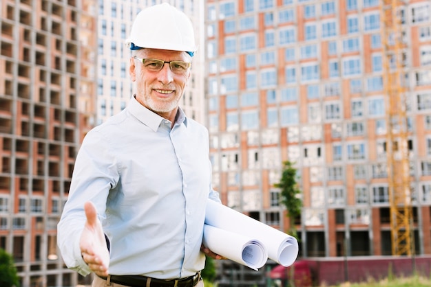 Front view old man with protection helmet and glasses 