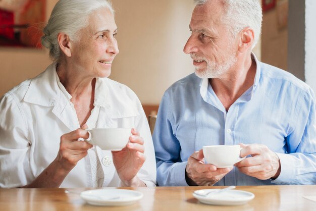 Front view old people looking at each other