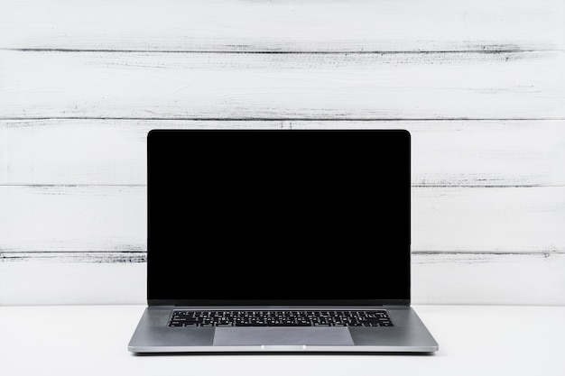 Front view opened laptop on wooden background