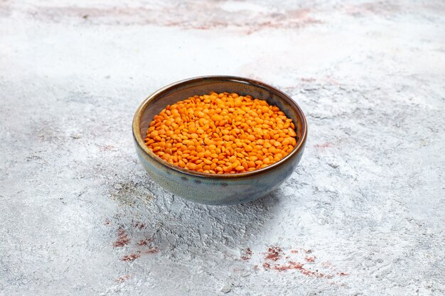 Front view orange raw beans inside plate on white surface bean raw food color