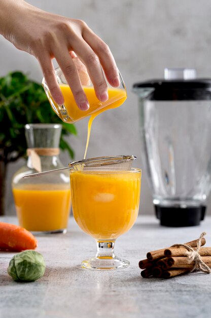 Front view orange smoothie arrangement on table