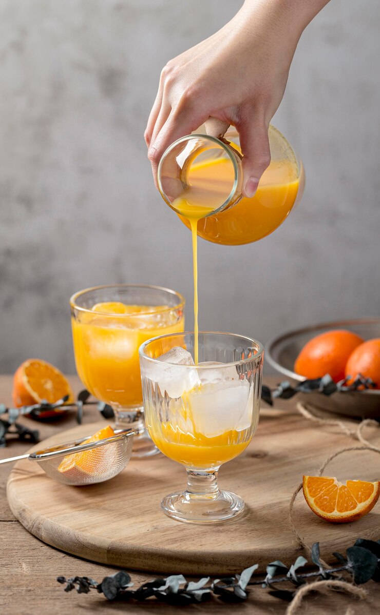 Free Photo front view orange smoothie assortment