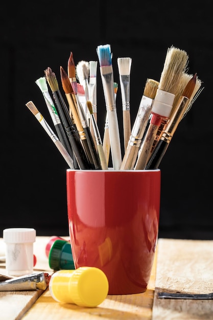 Front view of paint brushes in cup