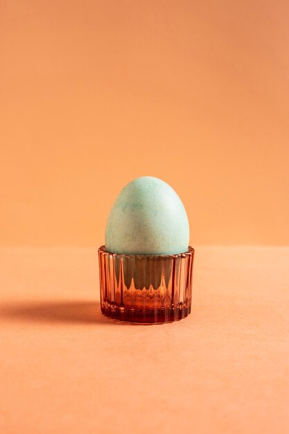 Front view of painted easter egg in egg holder