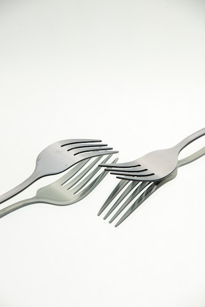 Front view pair of forks with reflection in the surface copy place stock photo