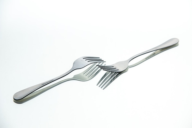 Front view pair of forks with reflection in the surface free place