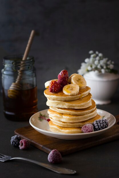 Front view pancakes with raspberries and bananas