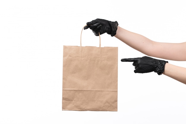 A front view papaer package hold by female with black gloves on white