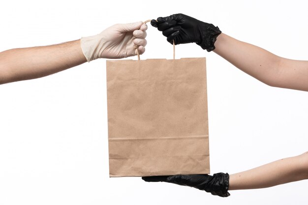 A front view paper food package delivering from female to male on white