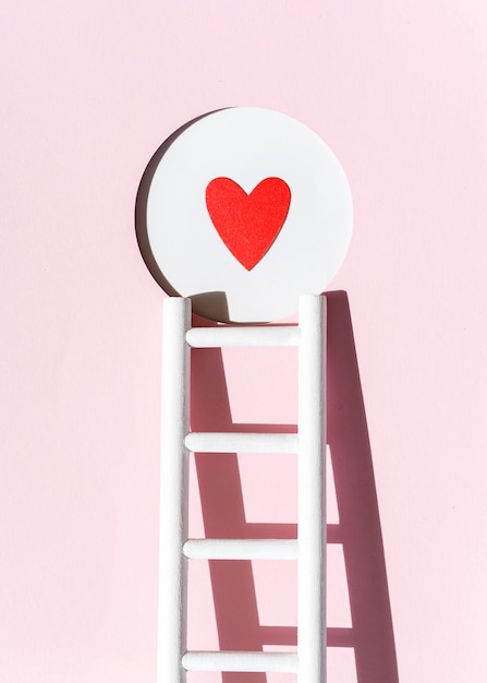 Free photo front view of paper heart with ladder