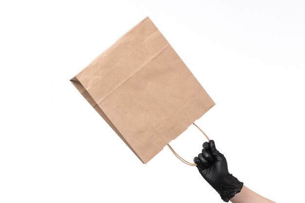 A front view paper package empty hold by female with gloves on white