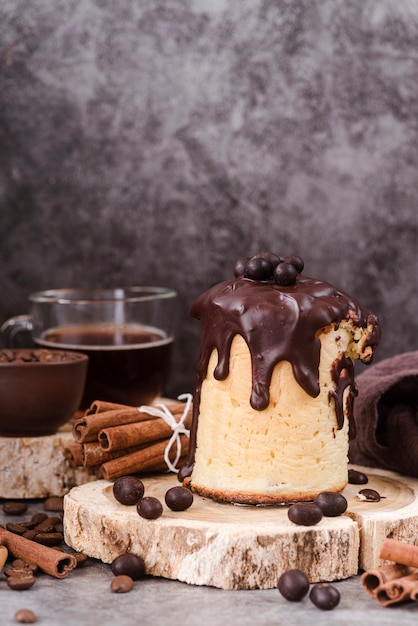 Free photo front view of pastry with chocolate topping and cinnamon sticks