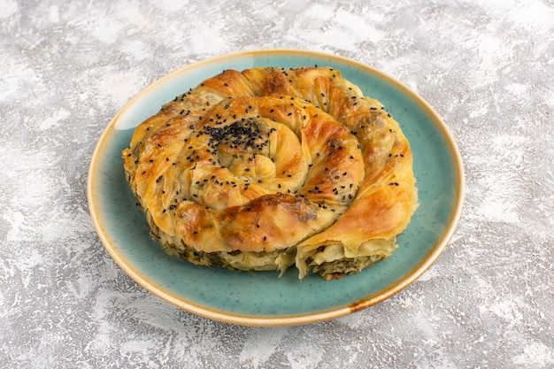 Front view pastry with meat delicious dough meal inside plate on light desk.