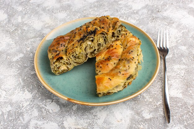 Front view pastry with meat delicious dough meal inside plate sliced on light desk.