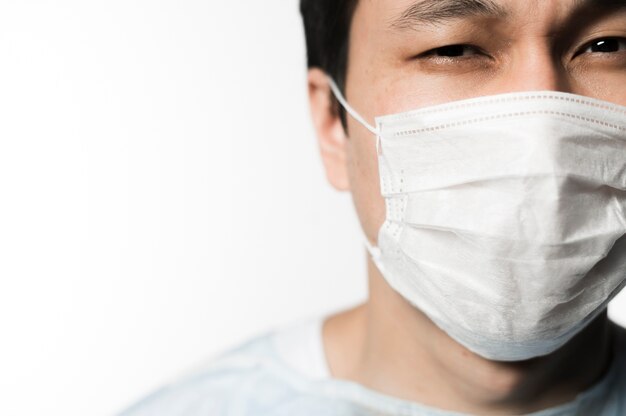 Front view of patient with medical mask and copy space