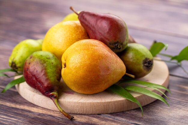 Front view of peaches on cutting board and wooden surface